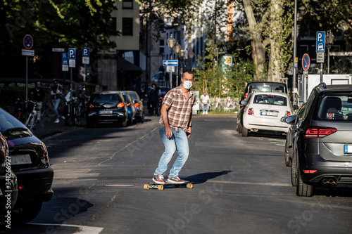 Man skateboarding in street at sunny day