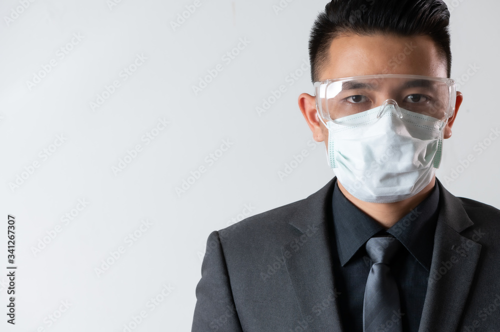 the abstarct image of the asian businessman were the protection mask and face shield. the concept of covit-19, work at home, quarantine, healthcare and business. the abstarct image of the asian businessman were the protection mask and face shield. the concept of covit-19, work at home, quarantine, healthcare and business.