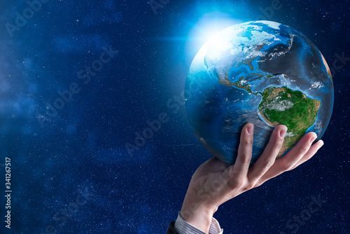 The abstract image of the businessman holds the marble earth on hand and element of this image furnished by Nasa. the concept of communication network, internet of things and future life