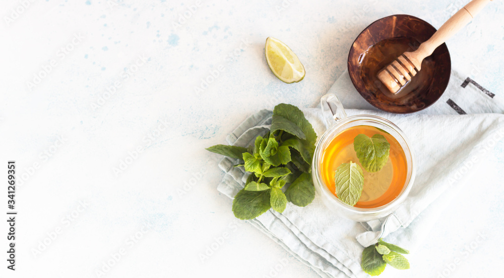 Glass mugs with traditional moroccan mint tea with honey and lime. Organic aromatherapy relaxation medical healthy beverage. Top view. Glass mugs with traditional moroccan mint tea with honey and lime. Organic aromatherapy relaxation medical healthy beverage. Top view.