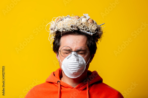 guy has a birds nest on his head out of boredom