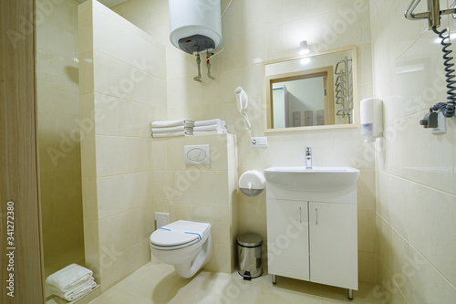 Bright bathroom  white toilet  washbasin  mirror  shower