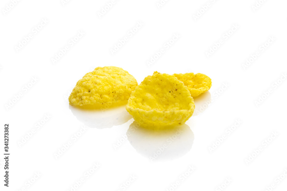 Healthy breakfast cereal background. Superfood Cornflakes isolated on white. Snack eat best with milk. Dieting and detoxication concept with mineral nutrients. Macro close-up shot. Healthy breakfast cereal background. Superfood Cornflakes isolated on white. Snack eat best with milk. Dieting and detoxication concept with mineral nutrients. Macro close-up shot.