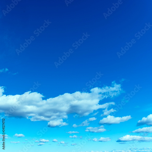 group of white cumulus clouds in the blue sky as a natural background