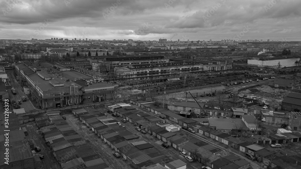 Aerial white and black photo of the workshops of the big factory on the dramatic sky background. Industrial and ecological concept. Aerial white and black photo of the workshops of the big factory on the dramatic sky background. Industrial and ecological concept.