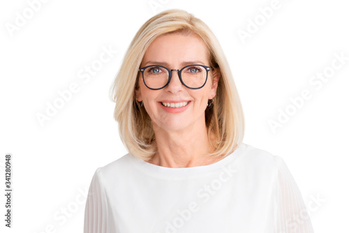 Attractive senior woman standing with arms crossed at isolated white background photo
