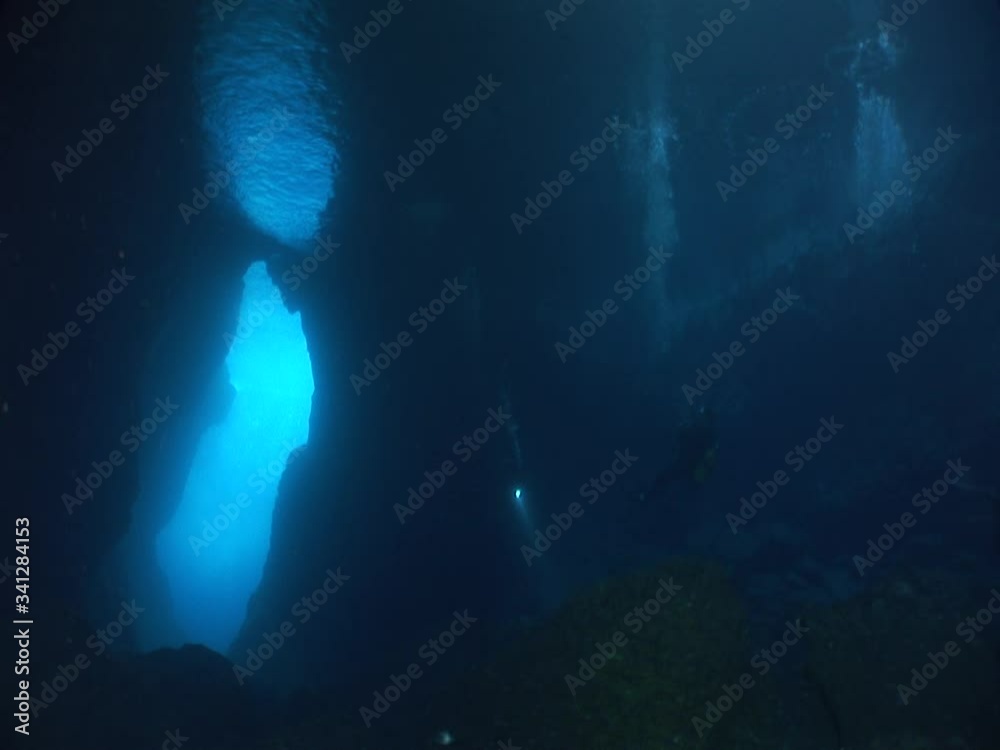 scuba divers are exploring the caves underwater cave dive ocean scenery with torch lights scuba divers are exploring the caves underwater cave dive ocean scenery with torch lights