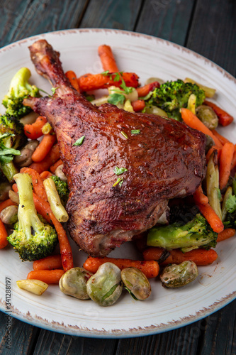 Grilled lamb leg. Juicy meat with vegetables.