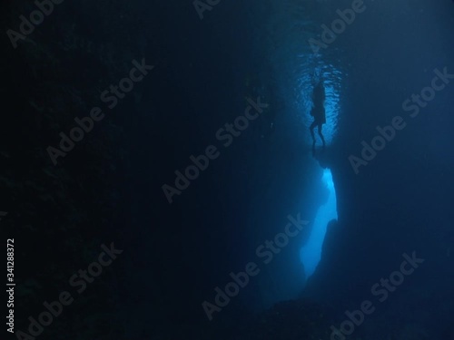 Wallpaper Mural scuba divers are exploring the caves underwater cave dive ocean scenery with torch lights Torontodigital.ca