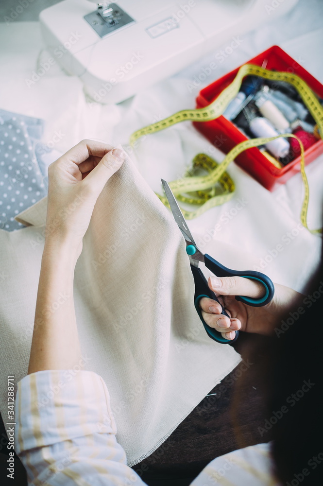 girl master scissors cuts the fabric. handmade. tailor