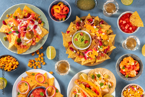 Mexican food variety, shot from above. Nachos, guacamole, tequila, tacos and other dishes, a flat lay