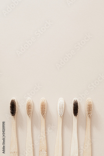 Bamboo toothbrushes on a beige background photo