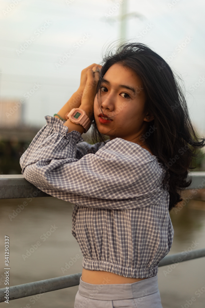 A young beautiful girl poses on an old bridge. A young beautiful girl poses on an old bridge.