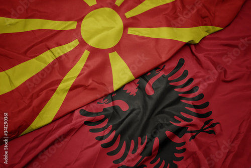 waving colorful flag of albania and national flag of macedonia. photo