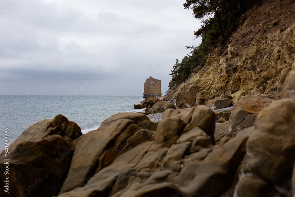 Stones beach at the sea in dark day