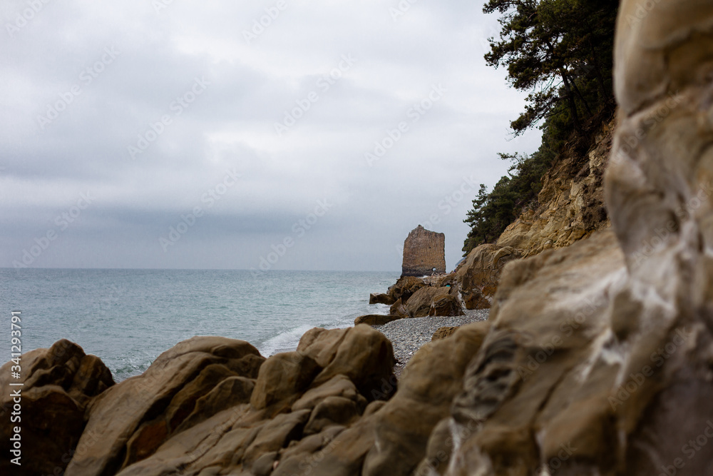 Stones beach at the sea in dark day