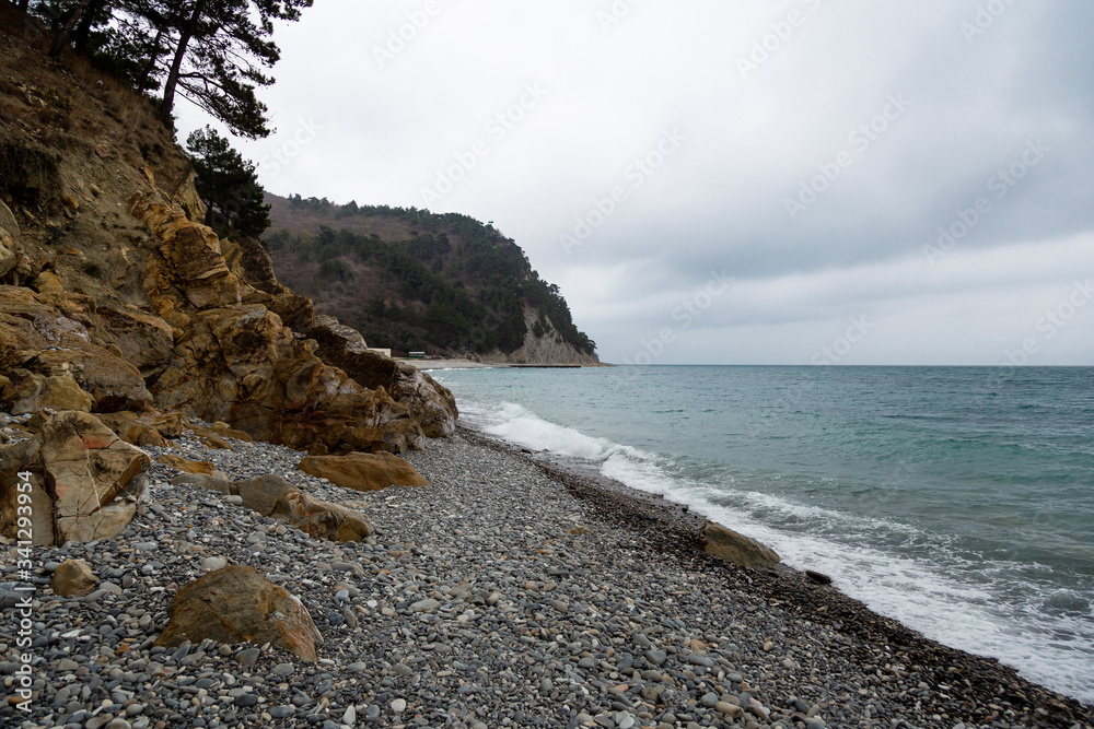 Stones beach at the sea in dark day
