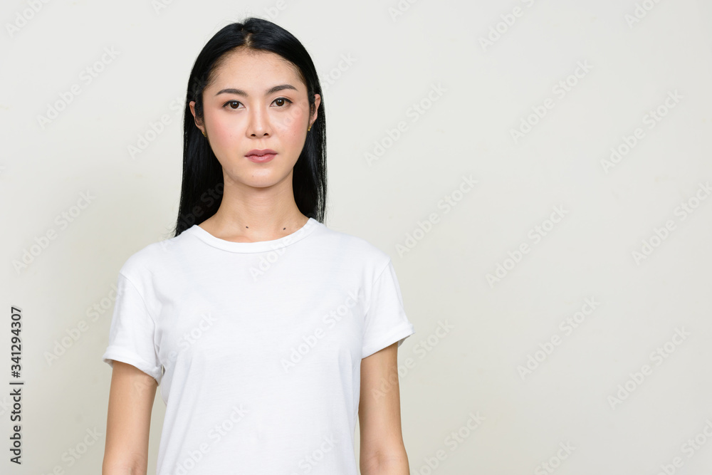 Portrait of young beautiful Asian woman looking at camera Portrait of young beautiful Asian woman looking at camera