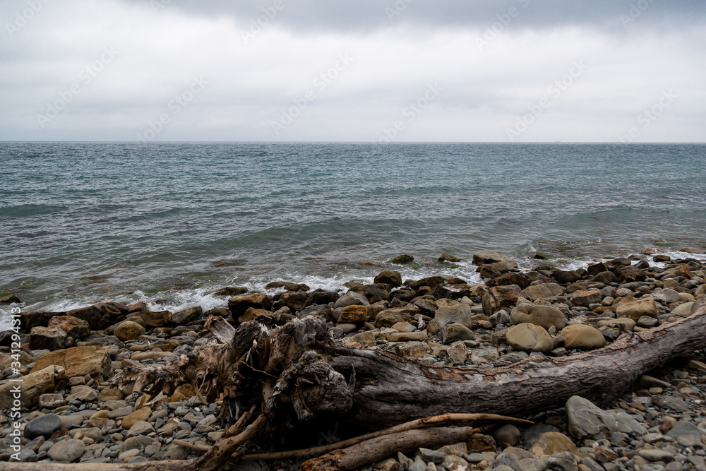 Stones beach at the sea in dark day