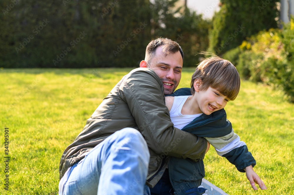Kid and father playing on grass Kid and father playing on grass