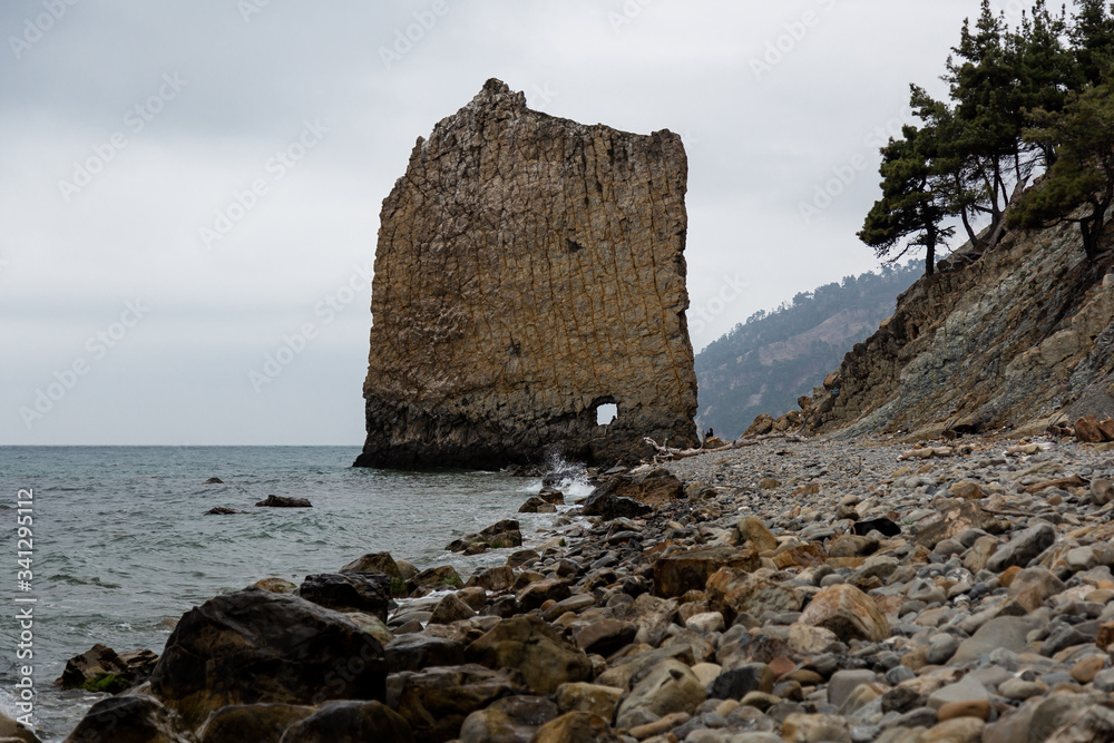 Stones beach at the sea in dark day