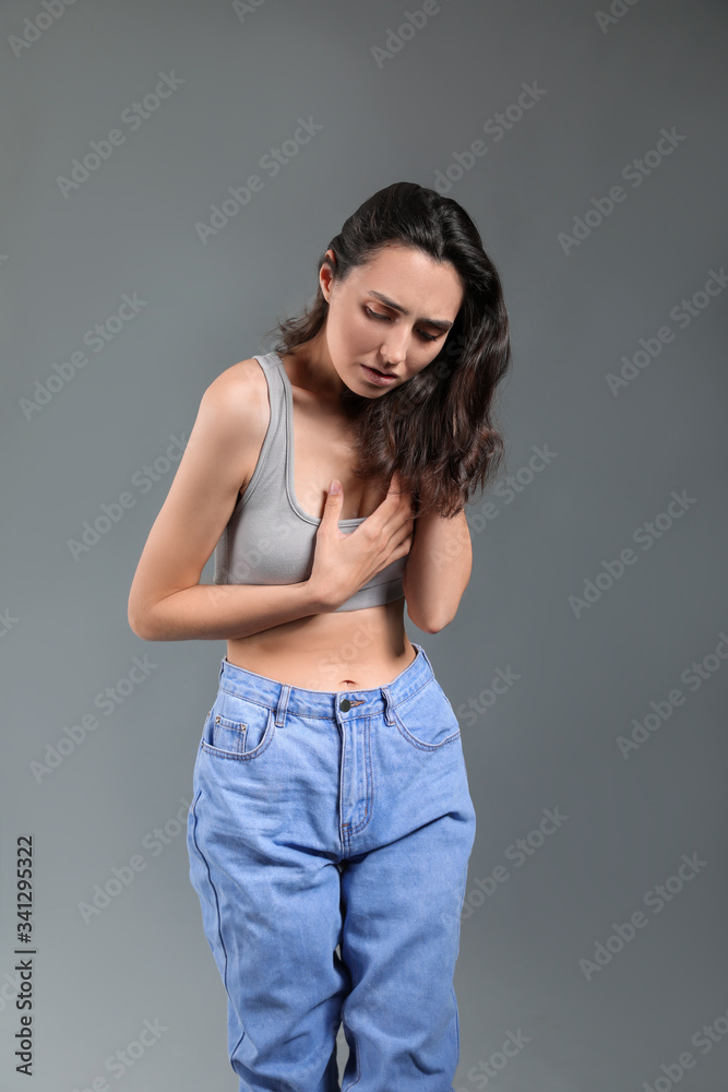 Young woman with anorexia on grey background Young woman with anorexia on grey background