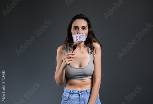 Sick woman with fork on gre...