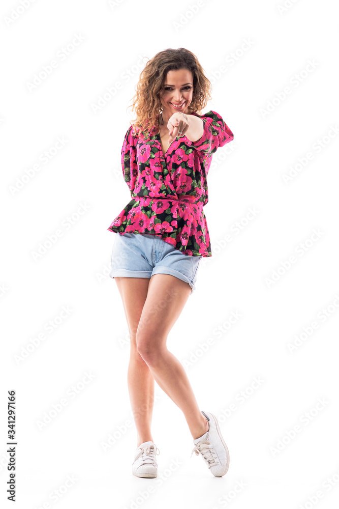 Happy friendly young summer girl pointing finger at you inviting to join team or party. Full body isolated on white background. Happy friendly young summer girl pointing finger at you inviting to join team or party. Full body isolated on white background.