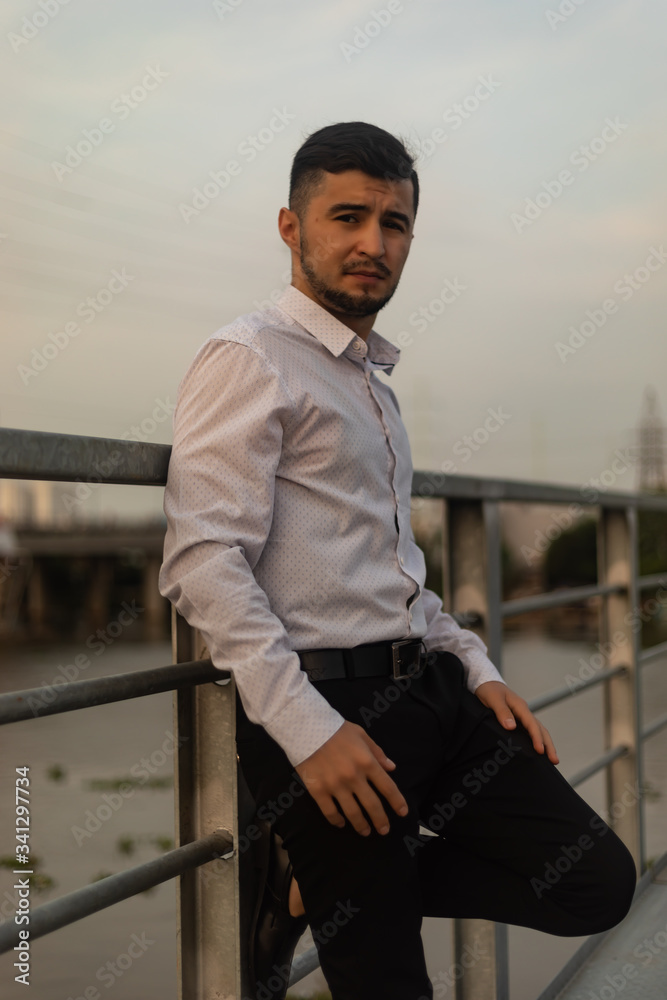 Man poses on an old bridge. Man poses on an old bridge.