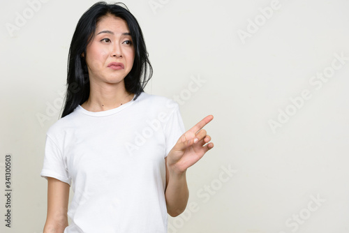 Portrait of stressed young Asian woman showing no gesture