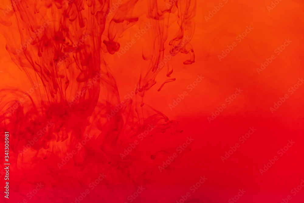 Close up red color ink Fluid liquid and smoke Abstract  background. Color drop flowing in water.