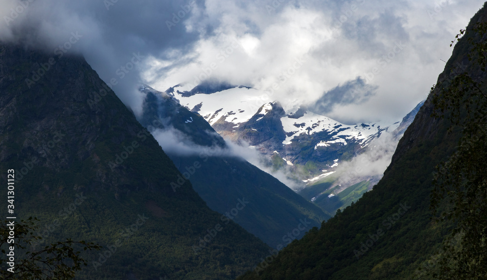 
Norway. View of the snow-capped peaks of the mountains under the clouds