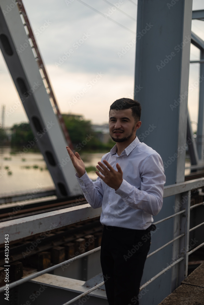Man poses on an old bridge. Man poses on an old bridge.