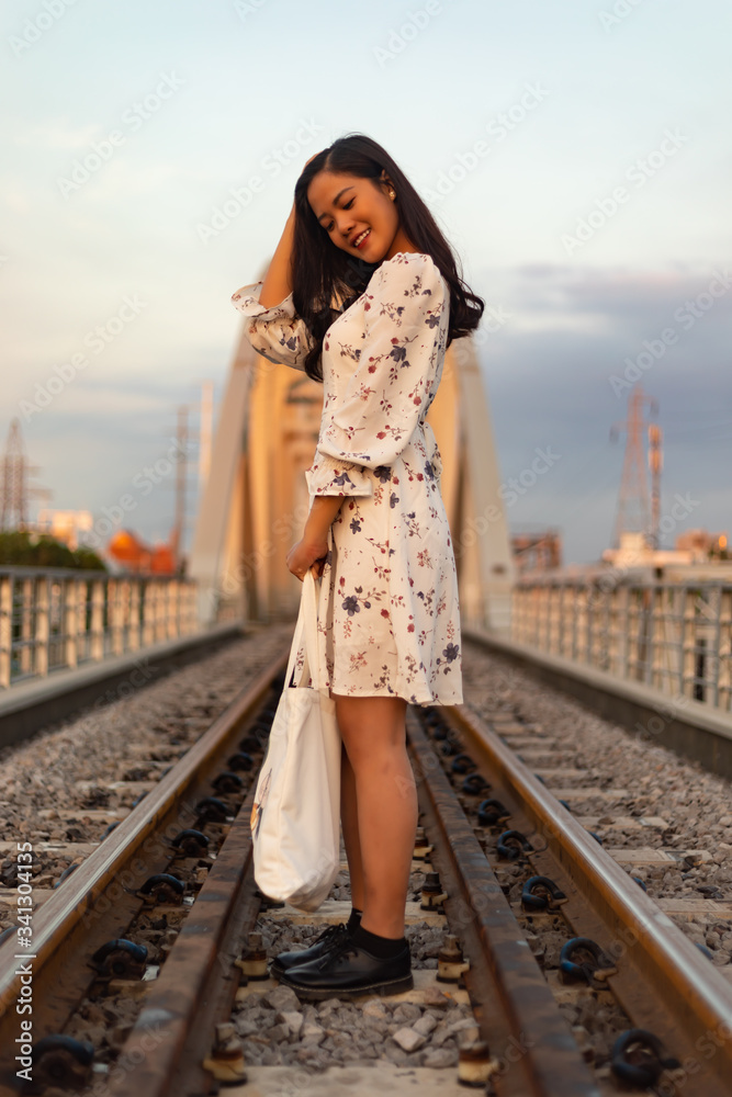 Vietnamese girl standing on an old bridge