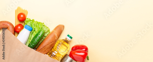 Grocery set in paper bag. Delivery service during quarantine, coronavirus covid-19. Horizontal banner. Top view