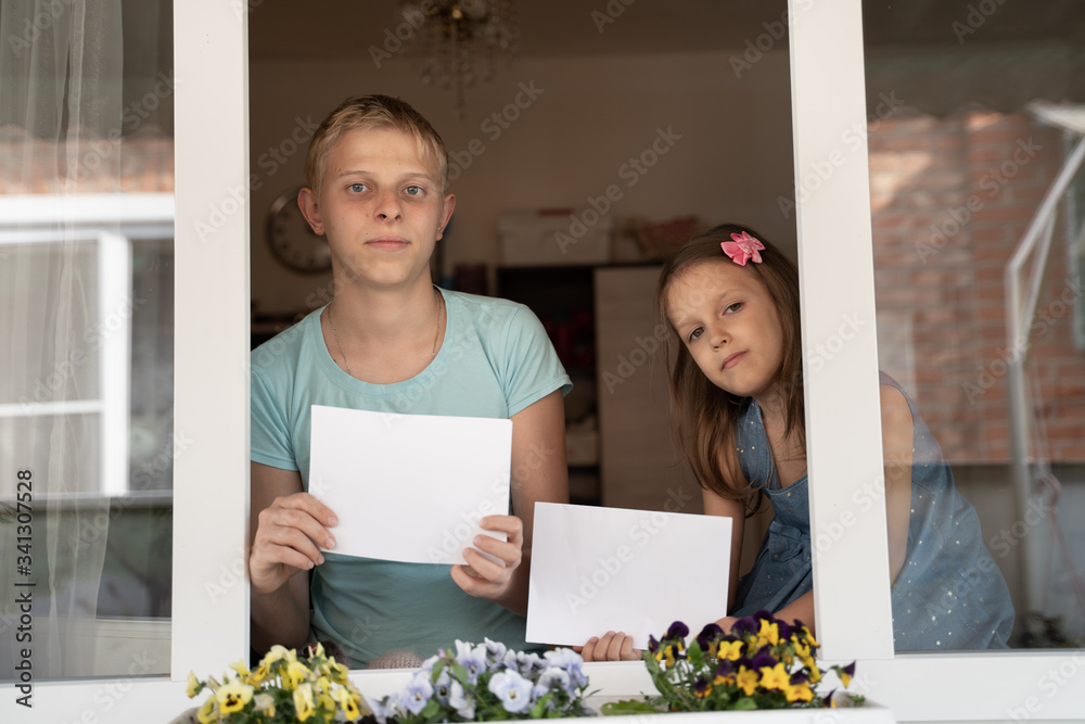 Two children look out the window. Two children look out the window.