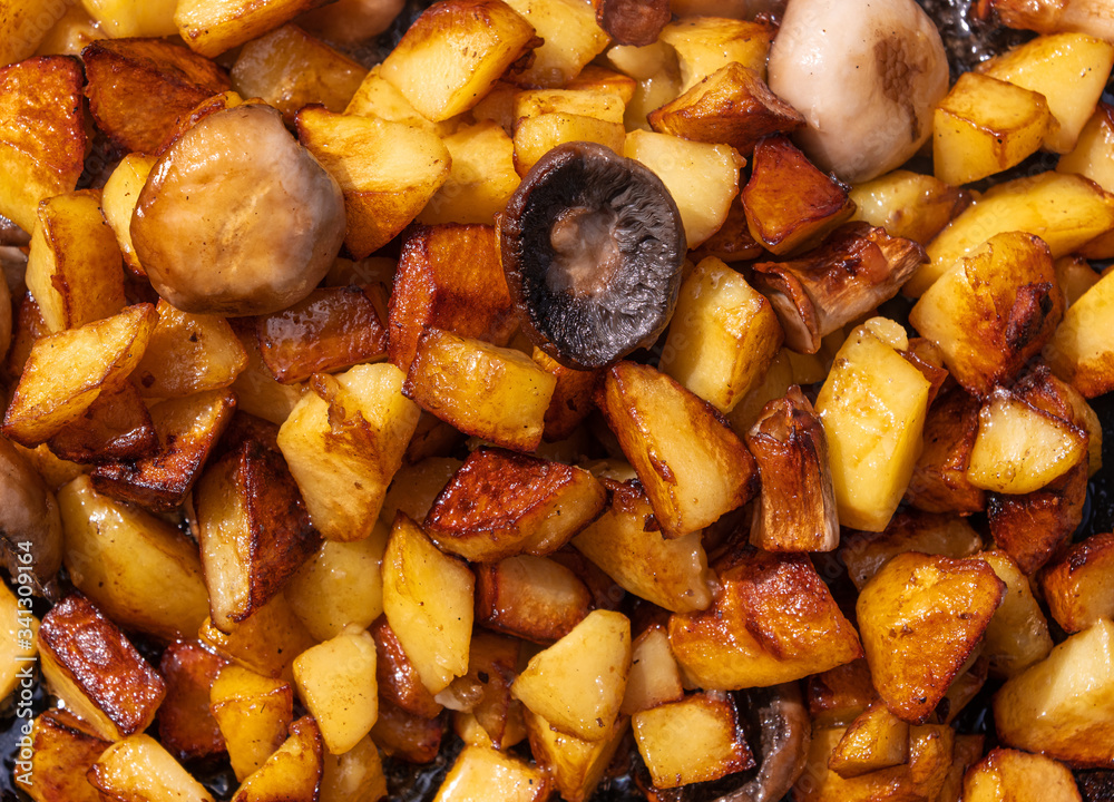 Fried potatoes with mushrooms background