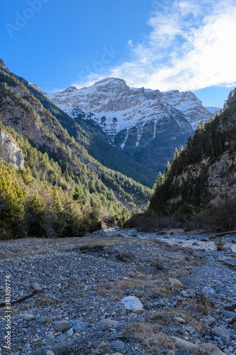 LANDSCAPE OF RIVER AND MOUNTAIN IN THE ORDESA NATIONAL PARK IN THE PYRENEES OF SPAIN