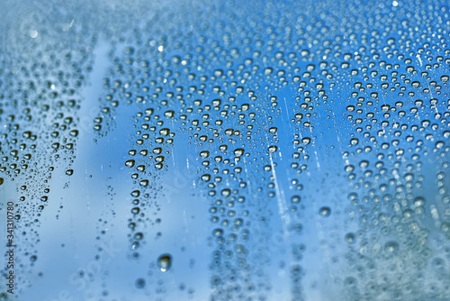 water drop on glass window raining background blue texture nature