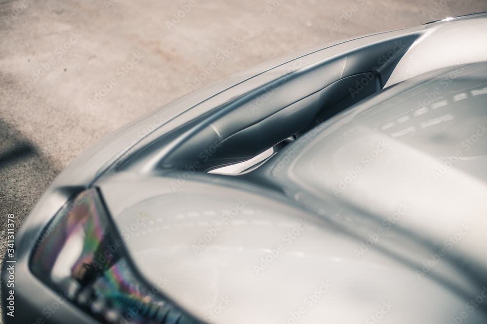 Obraz premium Front bumper and lights of a silver car