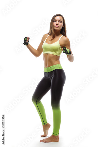 A young girl poses in sportswear on a white background © o_shi