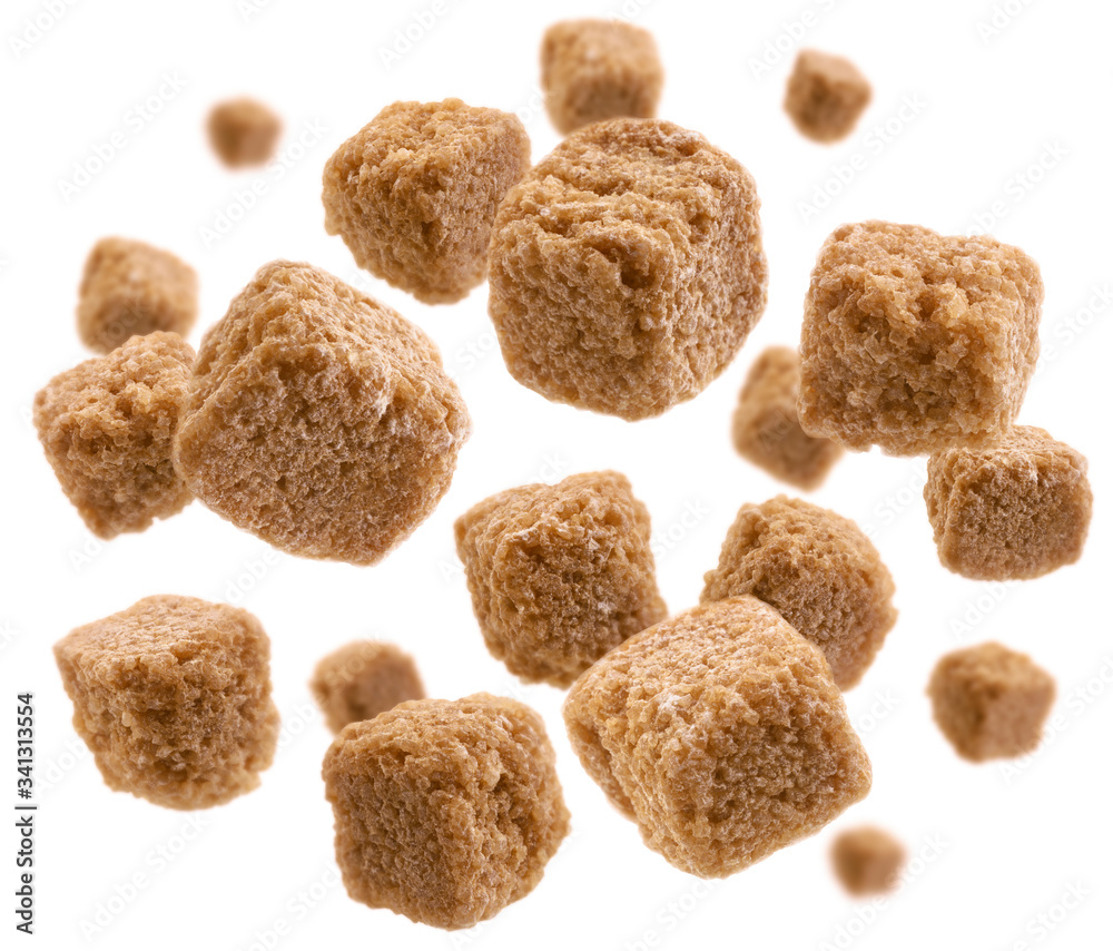 Brown cane sugar levitates on a white background Brown cane sugar levitates on a white background