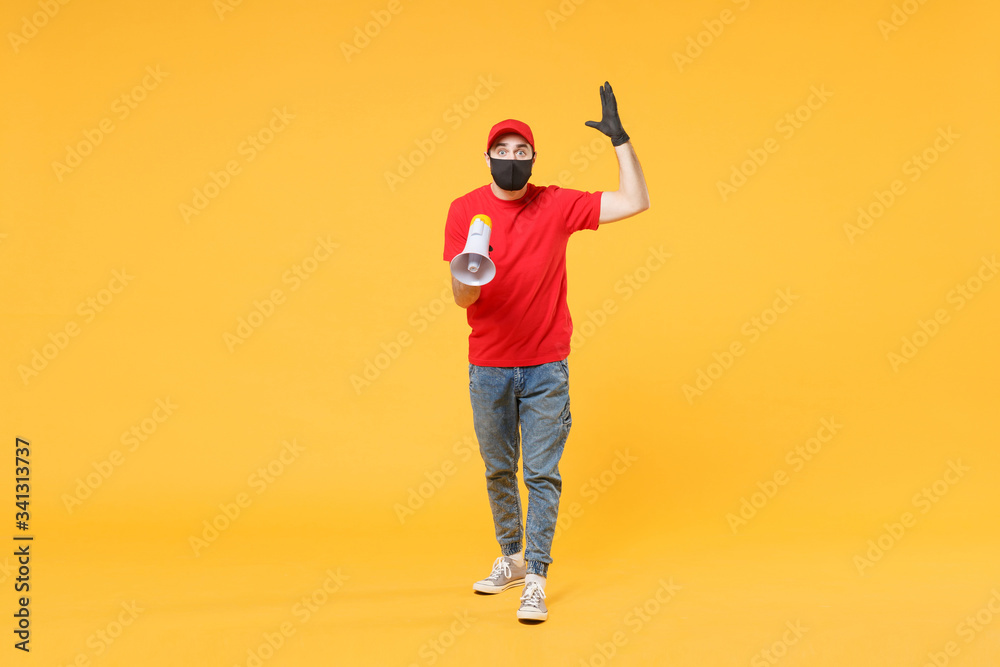 Delivery man in red cap blank t-shirt uniform mask gloves isolated on yellow background studio Guy fun employee working courier scream in megaphone Service pandemic coronavirus virus 2019-ncov concept Delivery man in red cap blank t-shirt uniform mask gloves isolated on yellow background studio Guy fun employee working courier scream in megaphone Service pandemic coronavirus virus 2019-ncov concept