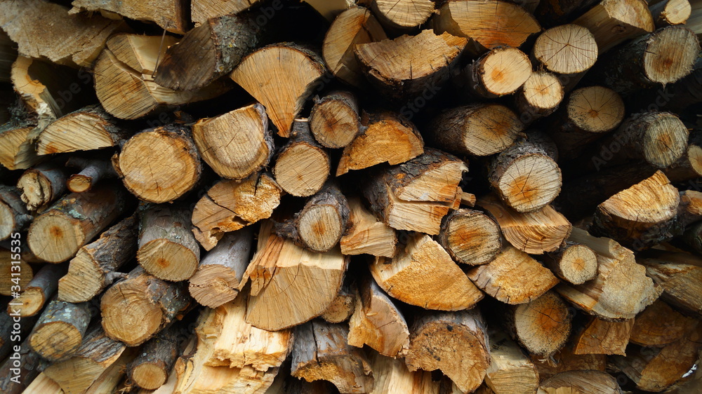 Background of dry chopped firewood logs in a pile Background of dry chopped firewood logs in a pile