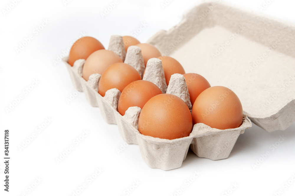 ten chicken eggs in a cage on a white background. isolated