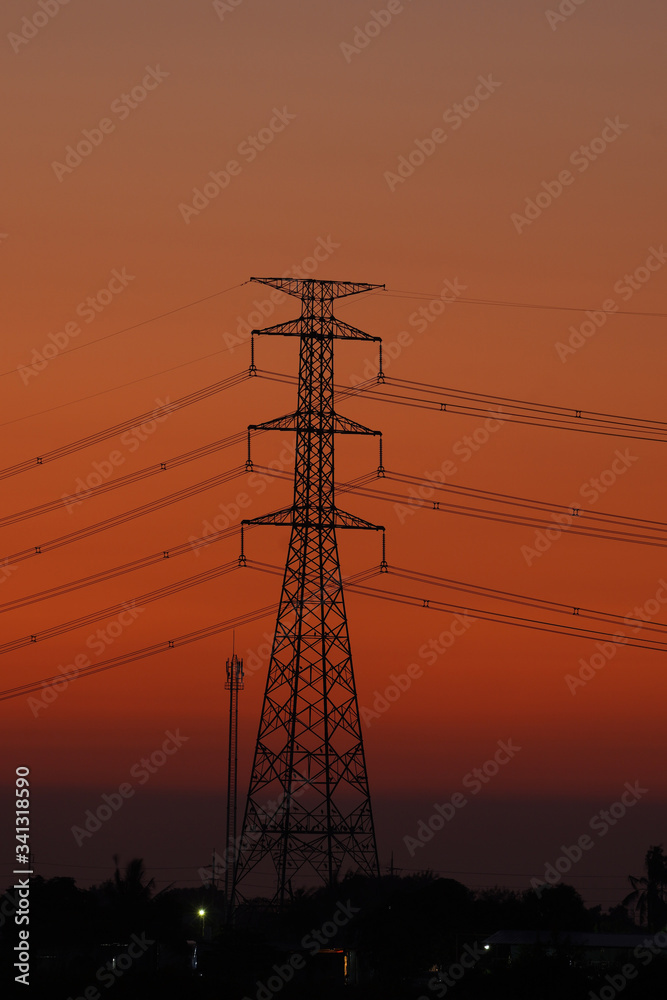 Fototapeta premium Vertical image, high voltage pole in the middle of the frame During Twilight Life There is beautiful light. Suitable for use as illustrations of content.