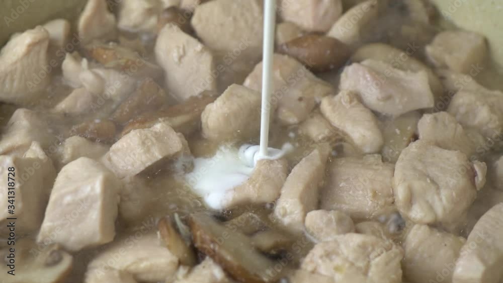 Adding Cream To Pan To Create Sauce. Pouring cream into a pan with frying chicken meat and mushrooms and boiling oil in it to make a cream sauce. Adding Cream To Pan To Create Sauce. Pouring cream into a pan with frying chicken meat and mushrooms and boiling oil in it to make a cream sauce.