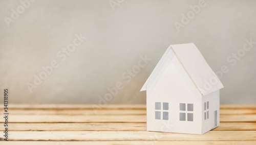 Paper house. On a wooden table.