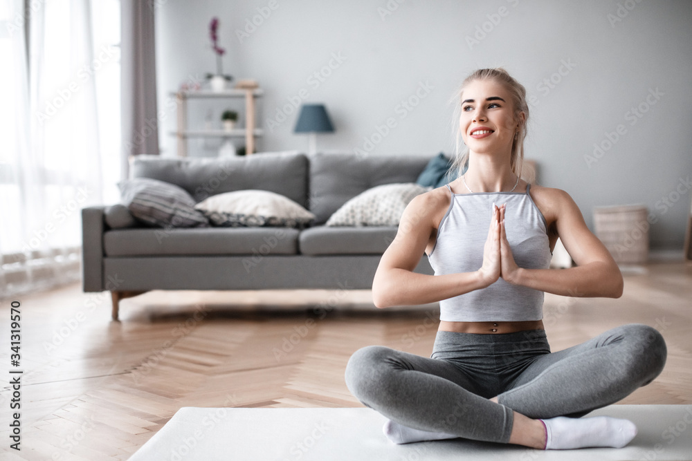 Beautiful young woman practicing yoga at home. Beautiful young woman practicing yoga at home.