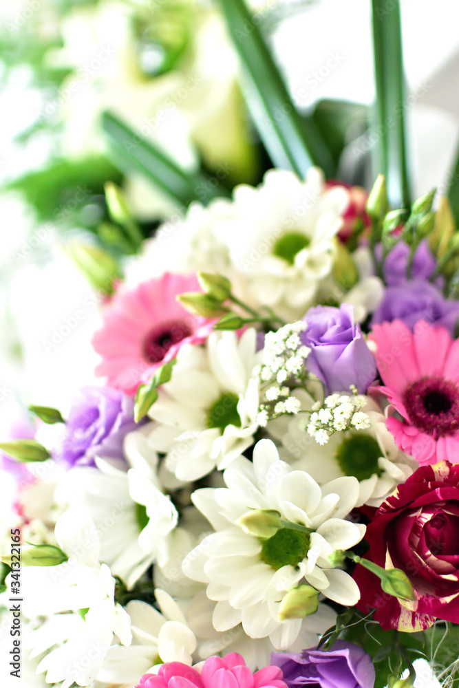 Close-up of wedding bouquet with pink and purple flowers. Vertical photo.